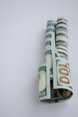 Wall Mural - Rolled dollars on a white background with copy space. American money.