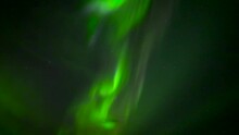 Green Aurora Borealis In The Night Sky With Stars. Beautiful Dancing Waves Of Light. Tilt-up