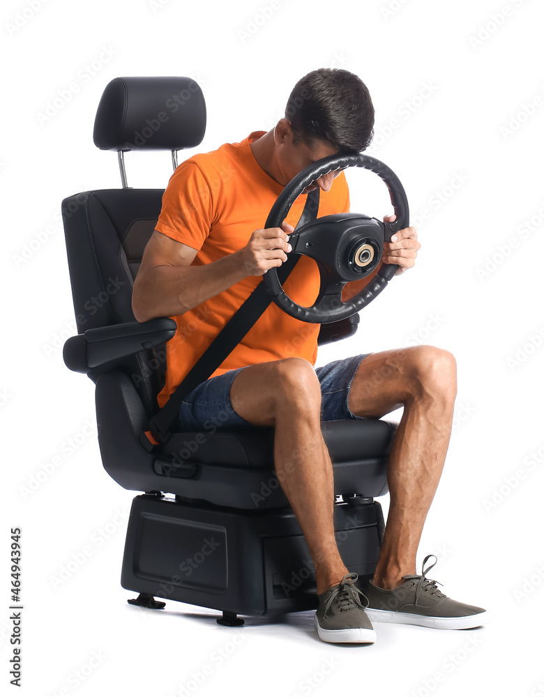 Stressed man in car seat and with steering wheel on white background