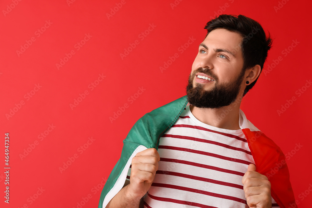 Handsome man with Mexican flag on color background