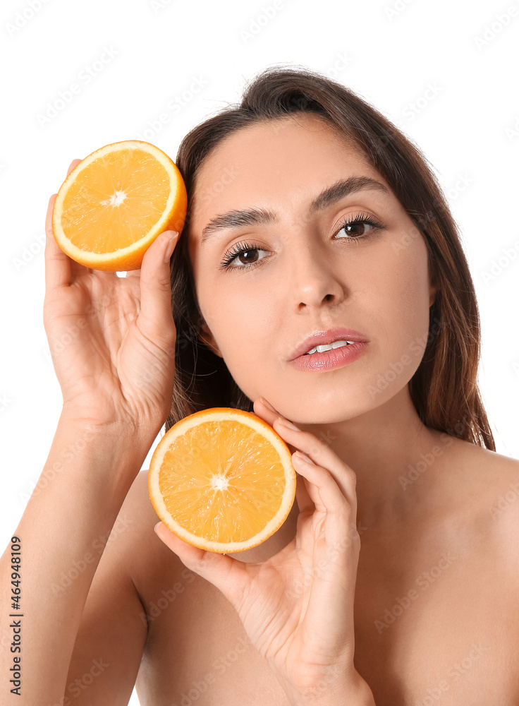 Naked young woman with cut orange fruit on white background. Vegan Day