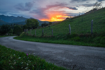 Wall Mural - Asphalt, winding mountain road during the spectacular sunset