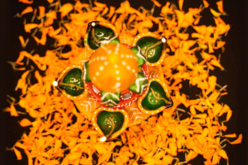 Wall Mural - Marigold Flower rangoli Design with oil lamps for Diwali Festival.