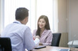 © PAPALAH - Doctor asking patient history, using a tablet to take notes, Asian woman.