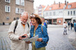 © Halfpoint - Portrait of happy senior couple tourists using map outdoors in town street