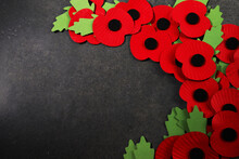 World War Remembrance Day. Red Poppy Is Symbol Of Remembrance To Those Fallen In War. Red Paper Poppies On Dark Stone Background