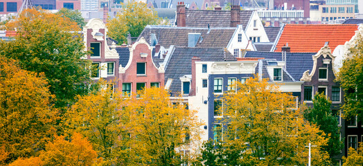 Sticker - Aerial view of the rooftops of old houses in Amsterdam. Golden autumn. Panoramic view of the city center. Amsterdam, Holland, Europe