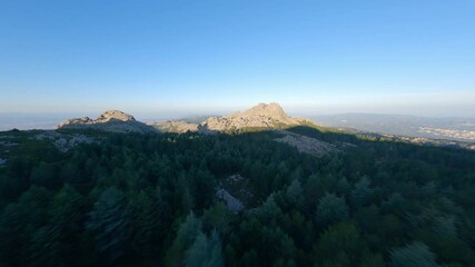 Wall Mural - FPV video, mountain surfing, flying at high speed over a granitic mountain range during a beautiful sunrise. Mount Limbara (Monte Limbara) Tempio Pausania, Sardinia, Italy.
