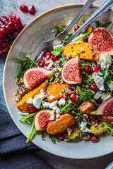 Warm autumn quinoa salad with baked vegetables, figs, feta cheese and pomegranate.