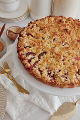 Poster - High-angle shot of the delicious homemade crumble pie with berries on a round ceramic plate