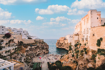 Wall Mural - Famous beach of Polignano a Mare in summer day with sky with white clouds