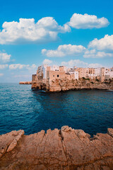 Wall Mural - View from the panoramic terrace of Polignano a Mare of the Apulian village in the province of Bari, sky with white clouds, vertical