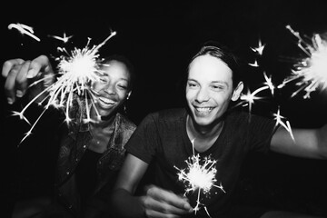 Wall Mural - Friends celebrating with sparklers in the night