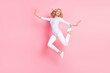 Full size photo of attractive young cheerful woman jump up gracious smile isolated on pink color background