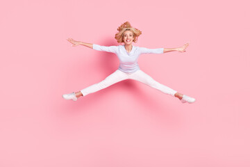 Poster - Full body photo of attractive young positive woman jump up dream travel isolated on pastel pink color background