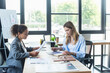 © LIGHTFIELD STUDIOS - Interracial businesswomen working with documents near smartphone and calculator in office