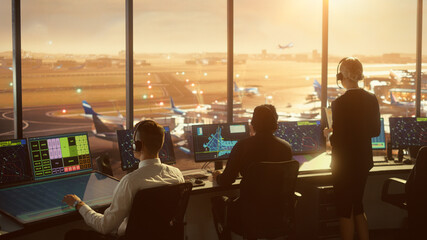 Wall Mural - Diverse Air Traffic Control Team Working in a Modern Airport Tower at Sunset. Office Room is Full of Desktop Computer Displays with Navigation Screens, Airplane Flight Radar Data for Controllers.