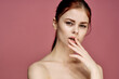 © VICHIZH - woman with bare shoulders charm cosmetics pink background posing