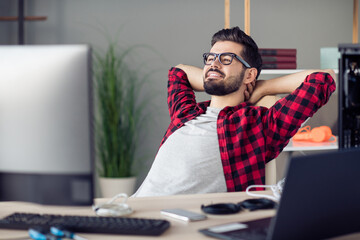 Poster - Portrait of attractive clever skilled cheerful guy resting in chair solving tech issues task project at work place station indoors