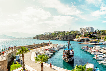 Wall Mural - pleasure yachts and boats at the pier in the port of Kaleici, the historical center of Antalya, Turkey. tourism and travel, a historical place for boat trips