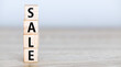 © roobcio - SALE words stacked with wooden letters on a wooden table.
