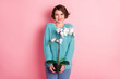 Photo of attractive positive young girl hold pot flower green plant wear blue jumper isolated on pink color background