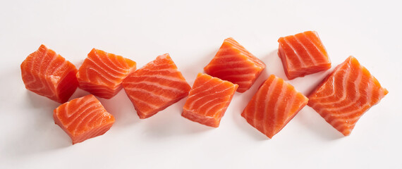 Sticker - Closeup shot of raw fresh salmon fillet cut in cubes placed on white background