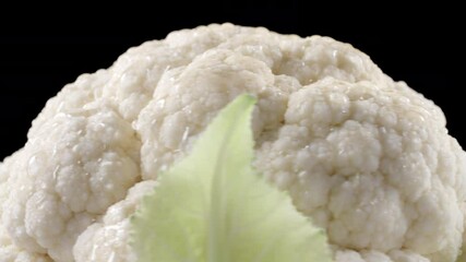 Wall Mural - Closeup shooting of rotating cauliflower on black background