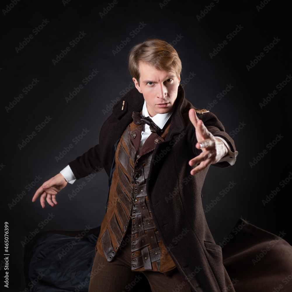 character of steampunk story, young attractive man in an elegant long coat,  adventurer makes an epic gesture. intelligent gentleman in Victorian style.  Vintage retro suit, young attractive man Stock Photo | Adobe, image size:1000x1000