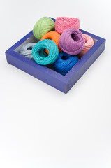 Sticker - blue wooden box with multicolored  decoration yarn with text space