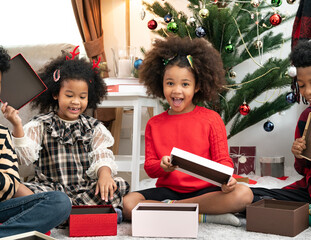 Wall Mural - Happy afro African American children pose in a room with gift box and Christmas decorations