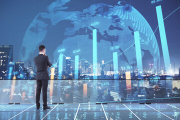 Aufkleber - Back view of young european male standing on glass rooftop with forex chart, globe and night city view. Trade and stock concept. Double exposure.