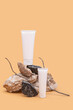 Two white tubes of cream or body lotion on a pieces of stone on a beige background. Modern still life product photo 
