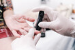 © Oscar Giraldo - hands of medical doctor with gloves taking blood glucose measurement