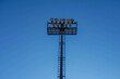 Photo of a lighting mast on a football field against a blue clear sky