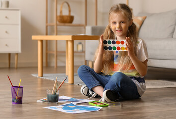 Wall Mural - Little girl with watercolors at home