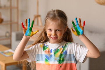 Wall Mural - Little girl with her palms in paint at home