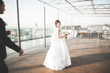 Gorgeous wedding couple walking in the old city of Lviv