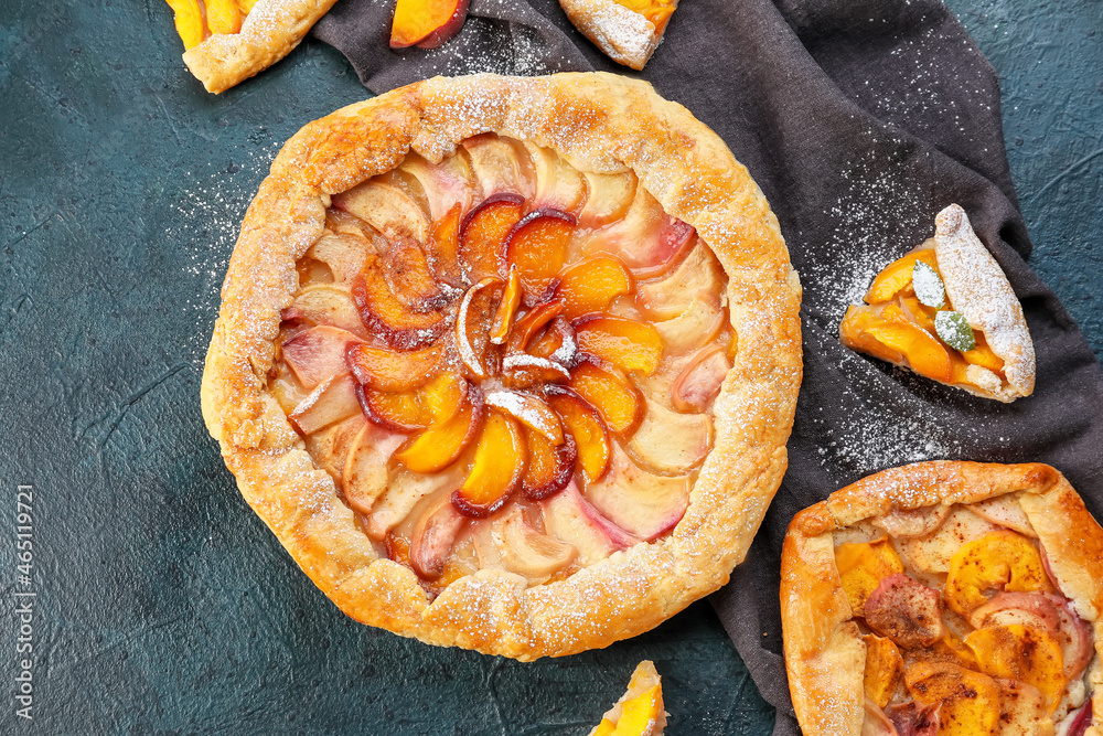 Tasty peach galettes on dark background