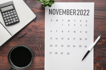 Sticker - Calendar page of November 2022, cup of coffee and stationery on dark wooden background. Black Friday