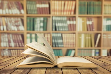 Wall Mural - open book on old wooden table in the library