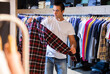 Man buys checkered shirt in the fashion store. High quality photo