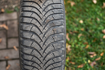 Wall Mural - Used black rubber winter tire with a protector.