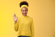 Cute timid friendly young girl wanna find new friends look pleasant smiling charmingly gladly waving hand hello hi gesture say welcome greeting heartwarming introduction herself, yellow background