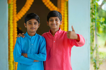 Wall Mural - Indian little boy in traditional wear and celebrating diwali festival.