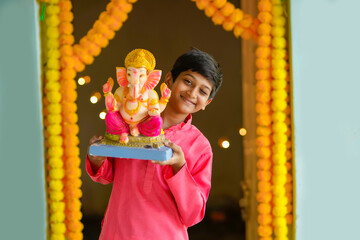 Wall Mural - Indian little child celebrate lord ganesha festival.