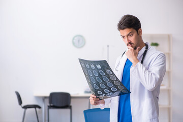 Wall Mural - Young male doctor radiologist working in the clinic