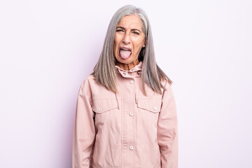 Wall Mural - middle age gray hair woman feeling disgusted and irritated, sticking tongue out, disliking something nasty and yucky