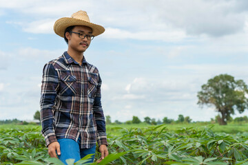 Happy Asain farmer standing in farm