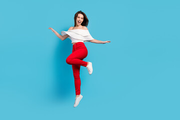 Canvas Print - Full size photo of sweet brunette young lady jump wear blouse jeans isolated on blue color background